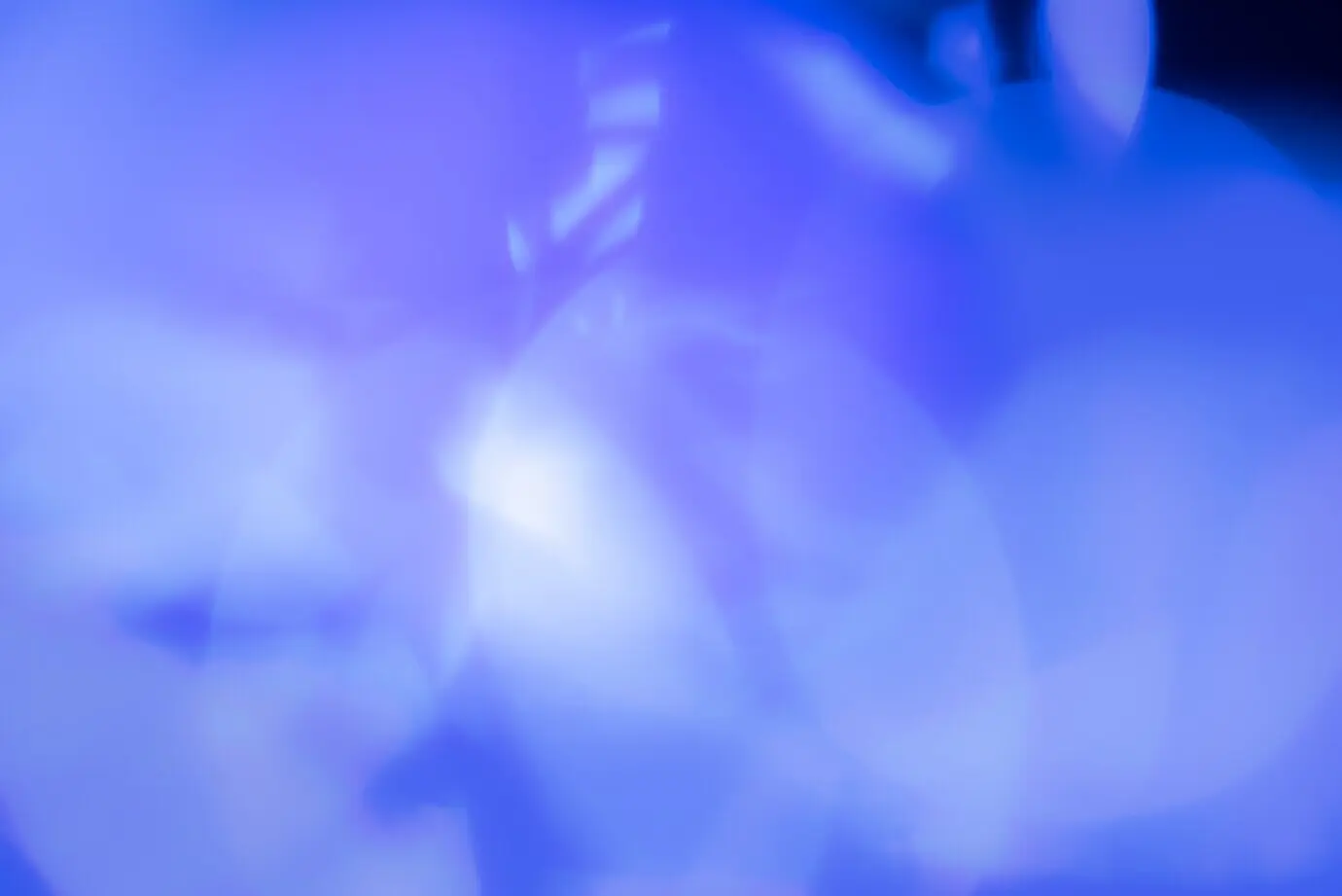 An abstract, blurry background with blue lights.